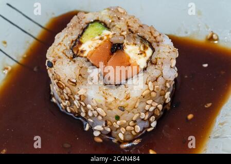 Das japanische Sushi-Essen ist ausgezeichnet. Maki und Brötchen mit Thunfisch, Lachs und Avocado. Draufsicht auf Sushi-Rolle. wasabi. Selektiver Fokus. Stockfoto