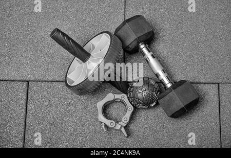Kettelglocken, Medizinball und Kurzhanteln auf dem schwarzen Fitnessboden, Fitnessgeräte. Sport-Übungsdesign. Flach liegend mit Textzeilen. Stockfoto
