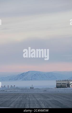 Wunderschöne Berge im Winter mit Schnee bedeckt und unter dem Hotel schimmert Der wolkig bunte Himmel Stockfoto