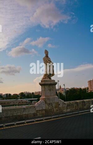 València, Comunidad Valenciana, Spanien, Europa. Barocke Steinstatue des Heiligen Thomas von Villanova (San Tomas de Vullanueva) an der Trinity Bridge (Puente de la Trinidad). Die Brücke wurde im gotischen Stil von Pedro Viñes im 14. Jahrhundert auf den Überresten einer maurischen Brücke aus Holz gebaut. Stockfoto