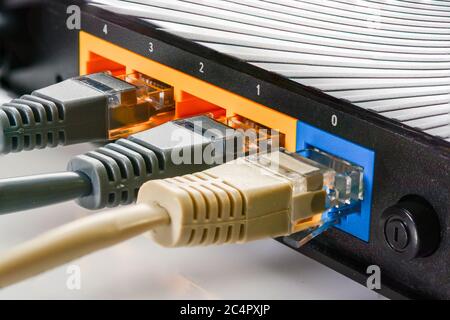 Internet-Router für Zuhause mit drei Kabeln mit rj-45-Anschlüssen, Internetverbindung. Konzept Heimnetzwerk, Nahaufnahme. Stockfoto