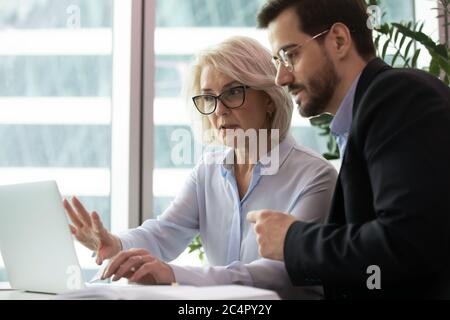 Ältere Geschäftsfrau kommunizieren mit Geschäftsmann Stockfoto