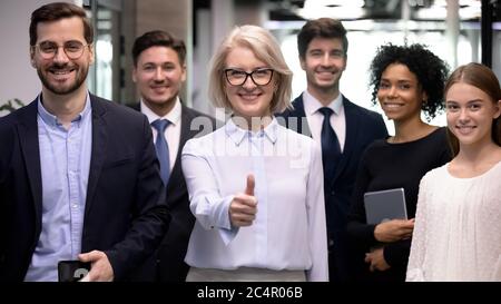 Erfolgreiche ältere Geschäftsfrau mit glücklichen Gruppe von Geschäftsleuten Stockfoto