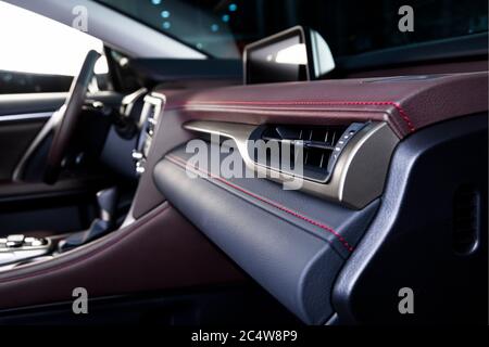 Luxuswagen im Inneren. Interieur von Prestige modernen Auto. Bequeme Ledersitze. Rred perforiertes Leder Cockpit. Stockfoto