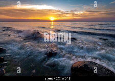 Felsbrocken im Meer im Wolin Nationalpark im Licht der untergehenden Sonne, Polen Stockfoto