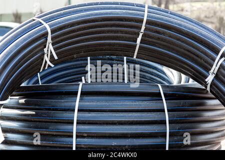Rolle von Hochspannungsnetzkabel schwarz auf im Freien isoliert, niemand. Stockfoto
