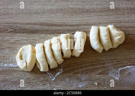 Frischer roher Hefeteig auf Holzküchentisch Stockfoto
