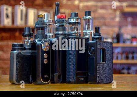 Elektronische Zigarette auf einem Hintergrund von vape Shop. E-Zigarette für VAPING. Beliebte vape Geräte Stockfoto