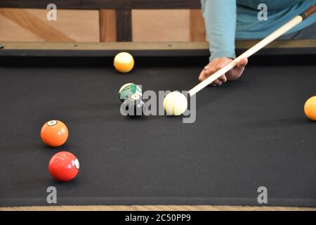 Schwarzer Billardtisch, Billard spielen - Nahaufnahme eines Mannes, der Billard spielt Stockfoto