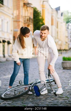 Mann mit Knie und Frau, die ihm hilft Stockfoto