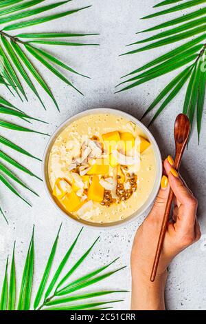 Tropische Mango und Kokosnuss Smoothie Schale, heller Hintergrund. Stockfoto