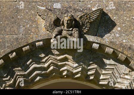 Kunstvolle Schnitzereien und Dekoration rund um die Eingangshalle der alten Kirche von St. Andrews in Holcombe, Radstock, Somerset, England, Großbritannien Stockfoto