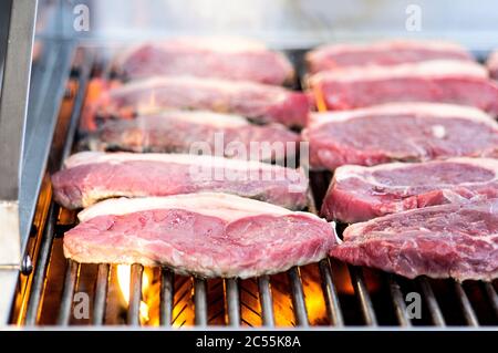 Rohe Steaks liegen auf einem offenen Grill Stockfoto
