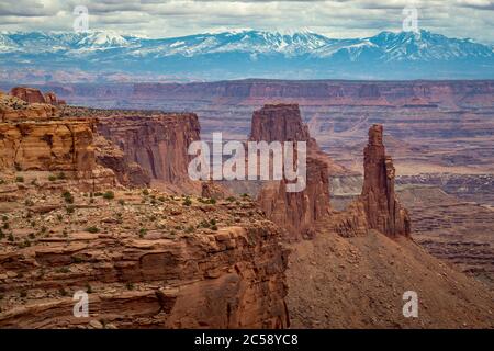 Wunderschöne Aussicht auf den Buck Canyon, mit Washer Woman Arch und Monster Tower im Vordergrund, Airport Tower im Mittelfeld und La Sal Mountains im Stockfoto