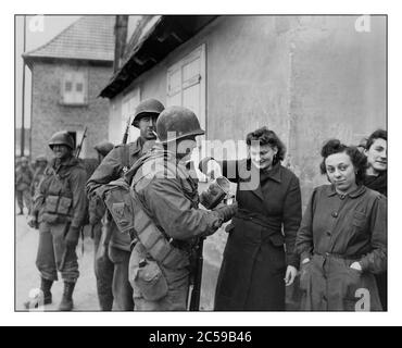 2. Weltkrieg 1945 ELSASS Frankreich amerikanische Soldaten der 79. Infanteriedivision erhalten Wein von französischen Zivilisten während einer Lull in den Kämpfen um Drusenheim, Frankreich am 6. Januar 1945. Im Februar 1945 wehrten die alliierten Truppen die deutsche Offensive erfolgreich ab, sicherten Drusenheim und trieben die Front näher an den Rhein. Die Befreiung Drusenheims war Teil der größeren Bemühungen, die in der Rheinüberquerung und der späteren Niederlage Deutschlands im Mai 1945 gipfelten. Zweiter Weltkrieg ELSASS Stockfoto