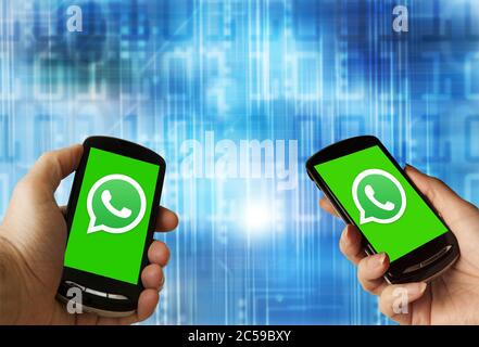 Hände mit einem Smartphone mit WhatsApp-Logo auf dem Bildschirm Stockfoto