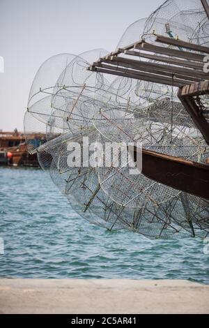 Al Khor Fischerhafen im Norden von Katar. Fischer, die den Kingfish von traditionellen Dhow Fischerbooten entladen. Stockfoto