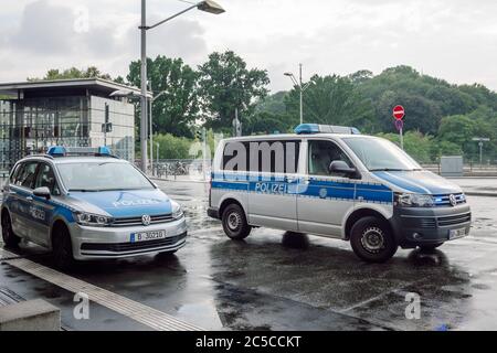 Berlin/Deutschland- 1. August 2019 zwei Polizeiautos der Berliner Polizei mit blinkenden blauen Lichtern parkten an einem verregneten Sommertag draußen. Stockfoto
