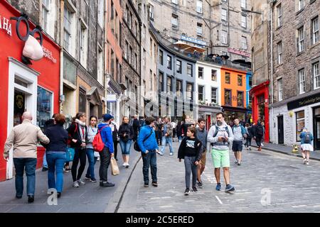 Bunte Geschäfte und Touristen an der berühmten Victoria Street in Edinburgh Stockfoto