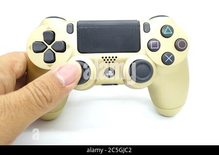 Ein goldener PlayStation 4 DS4-Controller vor isoliertem weißem Hintergrund Stockfoto