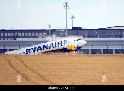 02. Juli 2020, Brandenburg, Schönefeld: Hinter einem Kornfeld von der abgesenkten Start- und Landebahn des Flughafens startet eine Boeing 737-800 Winglets der Fluggesellschaft Ryanair zum Flug nach Podgorica. Foto: Soeren Sache/dpa-Zentralbild/ZB Stockfoto