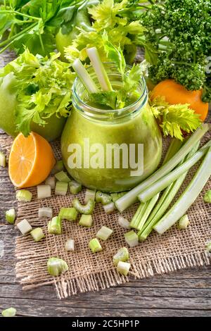 Frisch hausgemachter grüner Smoothie aus Sellerie, auf einem rustikalen Tisch. Detox und eine antioxidative Ernährung. Das Konzept der gesunden Ernährung und Lebensstil. Stockfoto