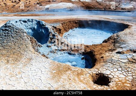 Mudpots in der geothermischen Bereich Hverir, Island. Den Bereich um den brodelnden Schlamm ist bunt und rissig. Stockfoto