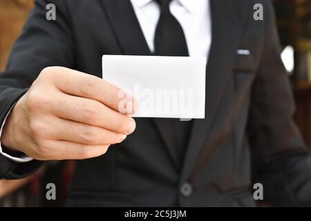 Nahaufnahme eines Geschäftsmannes, der weißes Stück Papier zeigt. Selektiver Fokus. Stockfoto