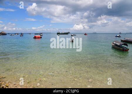 Sansibar, Tansania - 7. Oktober 2019: Fischerboote und andere Schiffe im Hafen von Stone Town, Sansibar, Afrika Stockfoto