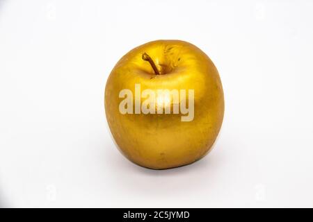 Ein goldener Apfel auf weißem Hintergrund Stockfoto