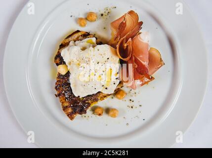 Brot mit Ricotta, Olivenöl und Prosciutto Stockfoto