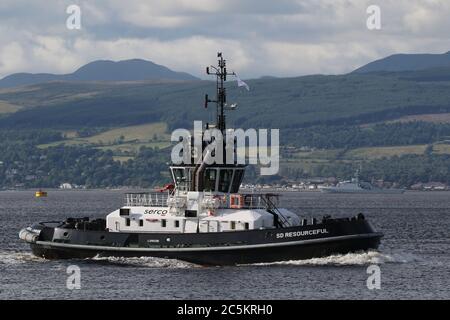 SD Resourceful, ein ATD 2909-Klasse Schlepper von Serco Marine Services, passiert East India Harbour in Greenock, mit HMS Tamar im Hintergrund. Stockfoto