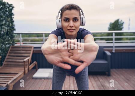 Attraktive junge Frau in Kopfhörer draußen arbeiten Stockfoto