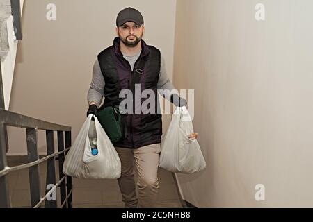 Der Kurier liefert die Ware. Lieferung in Kartons und Paketen. Stockfoto