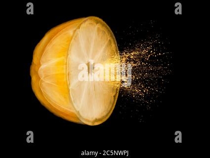 Eine halbe Orange zeigt Segmente, die Saft sprühen, farbige Röntgenstrahlung. Stockfoto