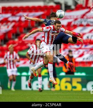 4. Juli 2020; bet365 Stadion, Stoke, Staffordshire, England; English Championship Football, Stoke City gegen Barnsley; Patrick Schmidt von Barnsley und James Chester von Stoke City springen für den Ball Stockfoto