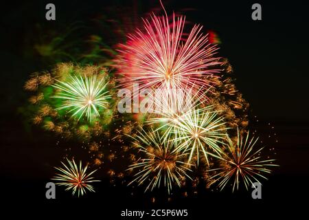 Helles, buntes Feuerwerk an einem festlichen Abend. Explosionen von farbigem Feuer am Himmel. Stockfoto