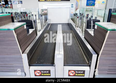 Leere, ungenutzte Check-in-Schalter, Gepäckabgabeschürtel am Flughafen Teneriffa Süd, Abflugbereich, aufgrund von Reisebeschränkungen für den Ausbruch des Coronavirus Covid-19. Stockfoto