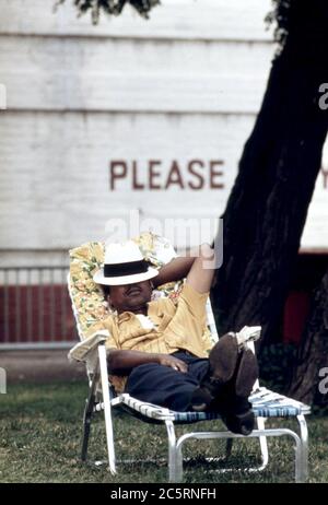 1973 - Schwarzer Mann bei EINEM Nickerchen in EINER Chaise Lounge auf der Südseite Chicagos, 08/1973 Stockfoto