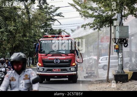 Makassar, Süd-Sulawesi, Indonesien. Juli 2020. Feuerwehrleute sprühten Desinfektionsmittel mit Autos auf den Straßen von Makassar, Indonesien. Das Spritzen wird regelmäßig durchgeführt, um die Ausbreitung des Covid-19-Ausbruchs zu verhindern. Quelle: Herwin Bahar/ZUMA Wire/Alamy Live News Stockfoto