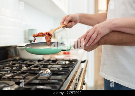 Nahaufnahme von unkenntlich reifen Paar Kochen Frühstück zusammen in der Küche mit Fokus auf Hände halten Bratpfanne, kopieren Raum Stockfoto