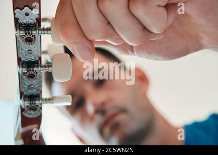 Mann Tuning Seine Akustische Gitarre Vor Dem Spielen Von Musik Stockfoto