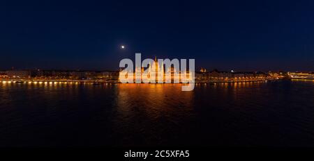 Panorama-Luftdrohne Aufnahme der Fassade des ungarischen Parlaments mit Licht in Budapest Nacht Stockfoto