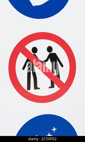 CV19, Covid-19 Schule Sicherheitsmassnahmen Warnschild & Warnpiktogramm am Tor der St. winnow Primary School, Lostwithiel. Piktogramm von Angesicht zu Angesicht Stockfoto