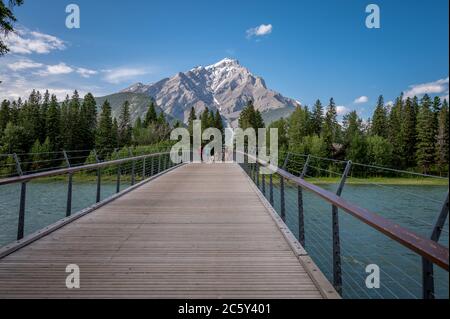 Banff, Alberta - 3. Juli 2020: Blick auf eine Fußgängerbrücke in Banff im Sommer. Banff ist die Hauptstadt im Banff Nationalpark und ein Zentrum von Touri Stockfoto