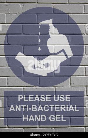Weiß verfaulte Backstein Wand Hintergrund mit bitte antibakterielle Hand Gel Zeichen verwenden, um die Ausbreitung der weltweiten Pandemie zu stoppen Stockfoto