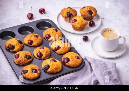 Hausgemachte Muffins mit Kirsche auf hellem Hintergrund. Stockfoto