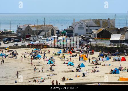 Lyme Regis, Dorset, Großbritannien. Juli 2020. UK Wetter: Der Strand ist mit Familien und Sonnenanbetern im Badeort Lyme Regis in Dorset an einem Tag der warmen Sonneneinbete beschäftigt. Bildquelle: Graham Hunt/Alamy Live News Stockfoto