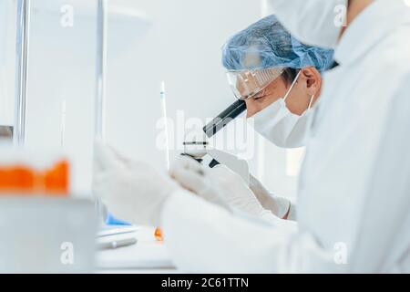 Nahaufnahme. Gruppe von Virologen in Schutzkleidung arbeitet im Labor. Stockfoto