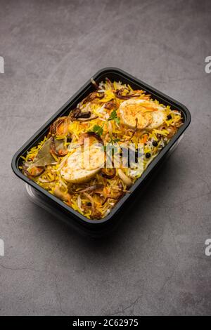 Restaurant Stil Ei Biryani oder Anda Pulao verpackt für die Hauslieferung in Plastikbox oder Container mit Raita und Salan Stockfoto